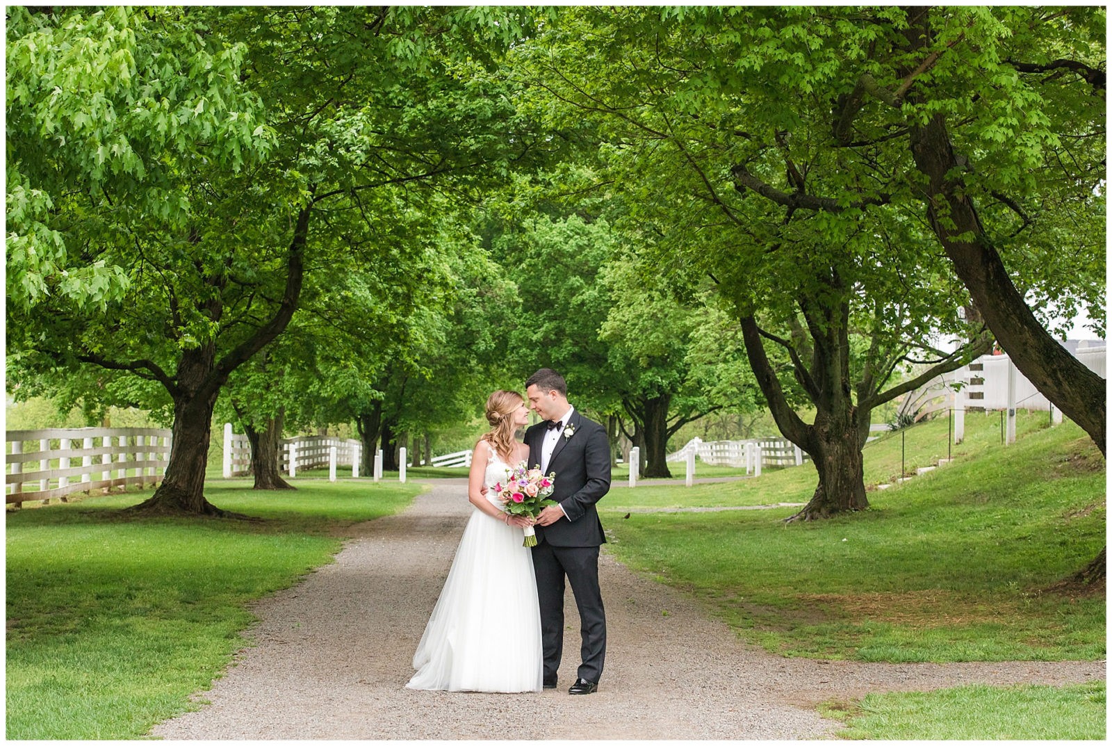 Bride and groom standing under a canopy of trees at Shaker Village in Harrodsburg, KY